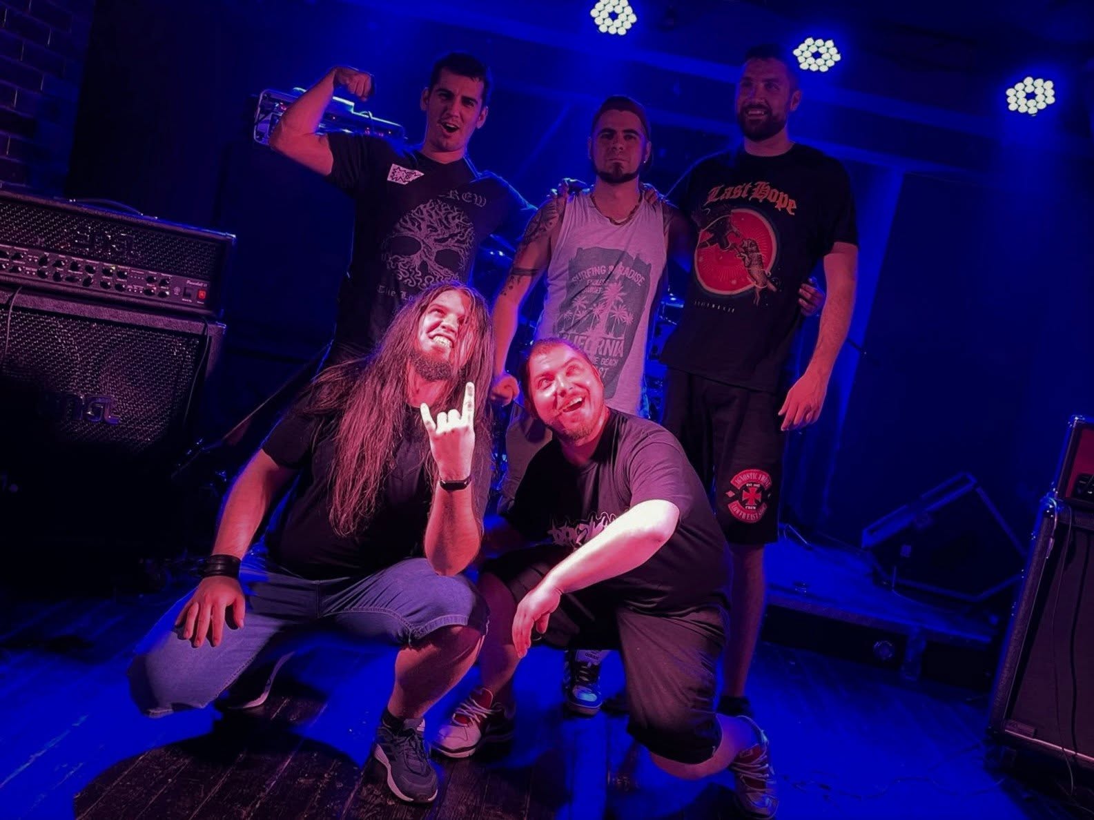 The five members of Broken together on stage