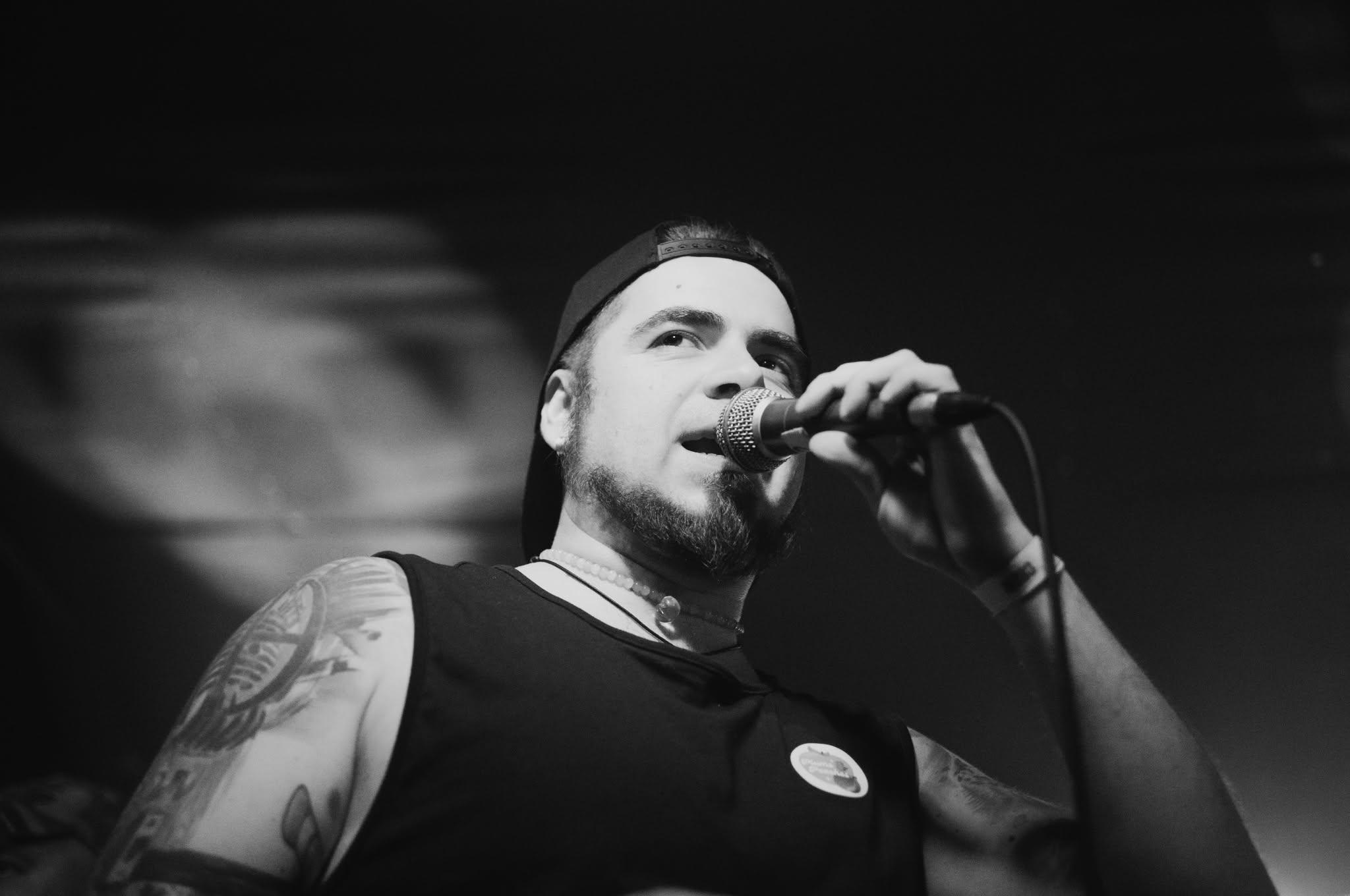 Broken singer holding a microphone during a live performance